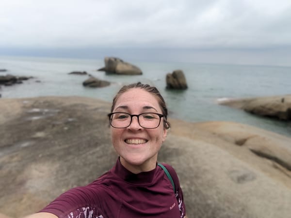 Amy, taking a selfie at a rocky beach near Kuantan, Malaysia